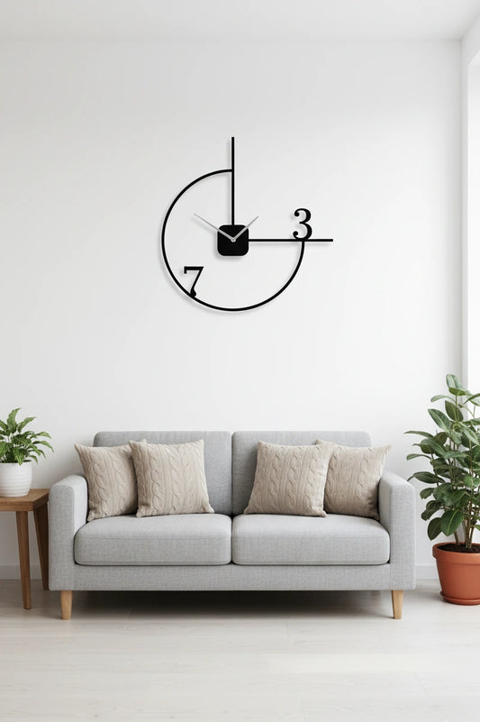 Modern living room with a gray sofa, decorative pillows, and a wall clock.