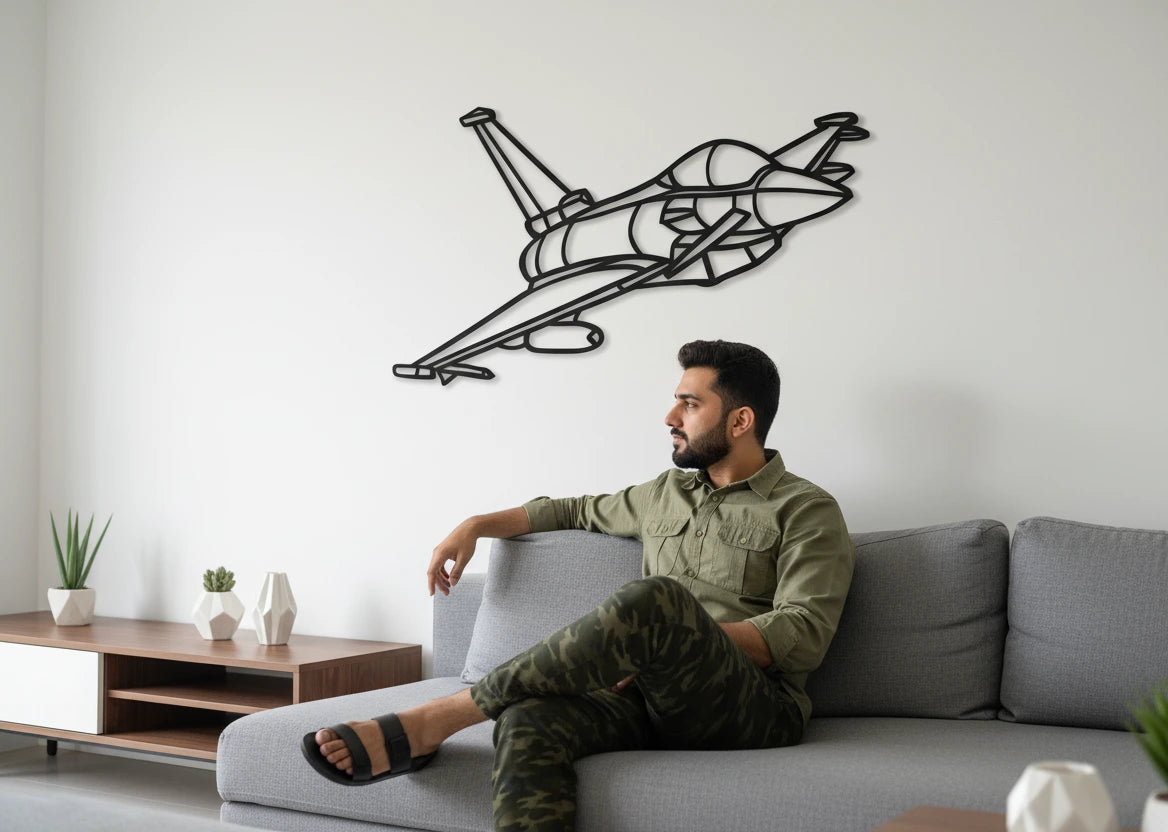 Man sitting on a couch in a living room with a geometric airplane wall art piece. fighter jet wall panel
