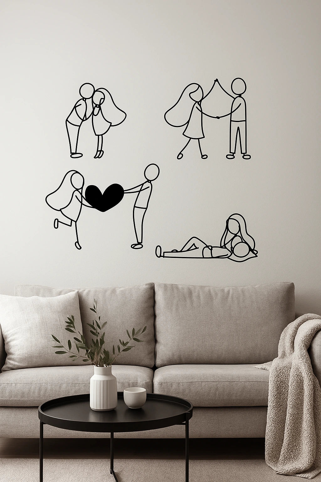 Wall with black line valentines day couple love art illustrations above a desk with a laptop, lamp, and plant.