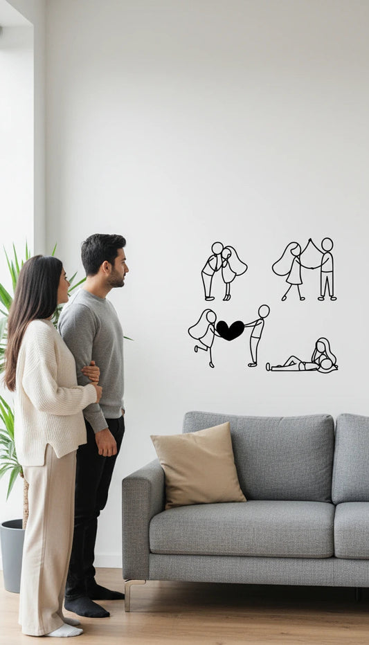 Two people standing in a living room with a wall decal of a couple holding hands.