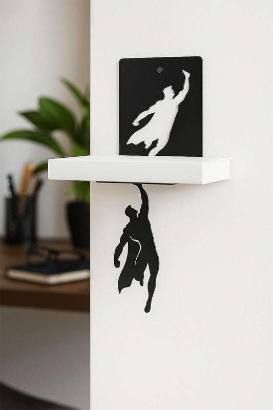 Black silhouette of a superhero on a white shelf with a blurred office background as a book holder