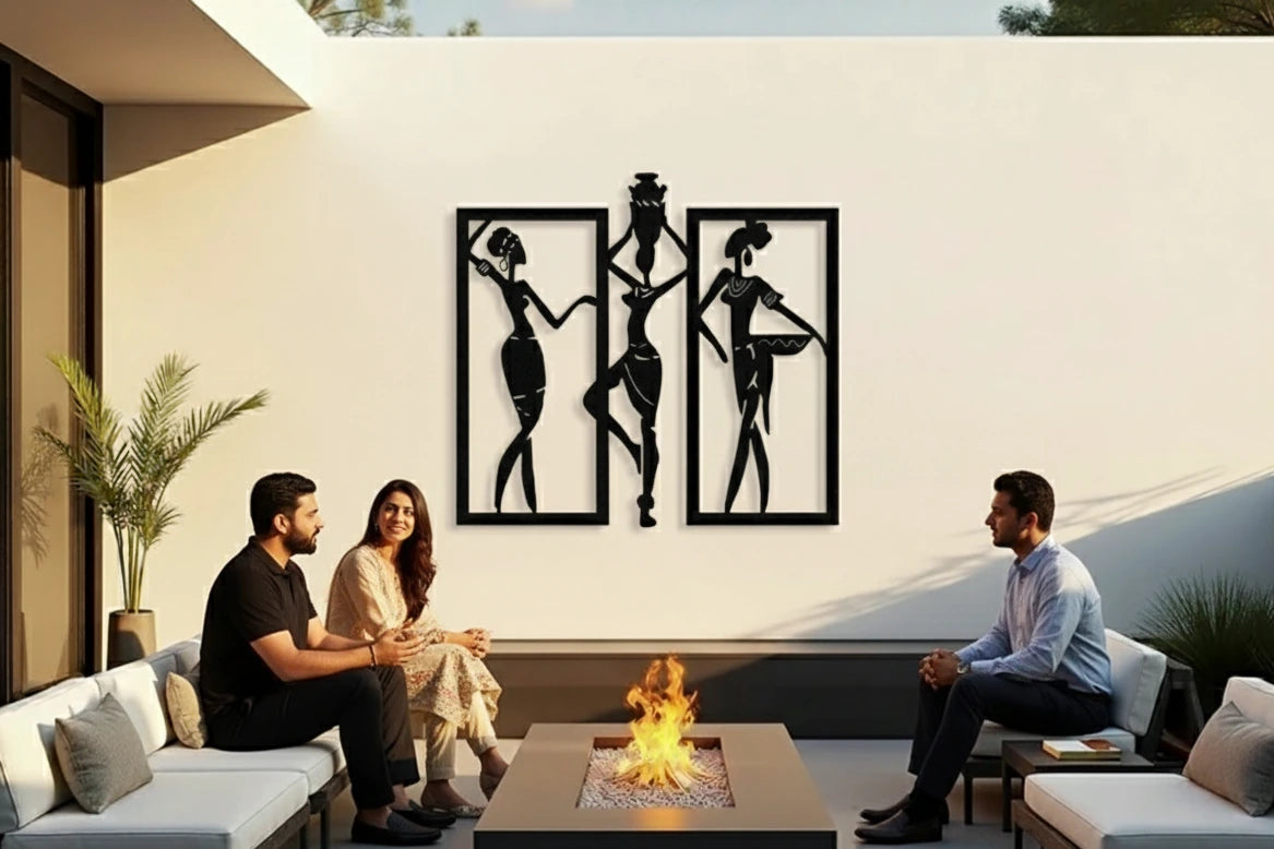 Two couples sitting on a patio with a fire pit and decorative wall art.