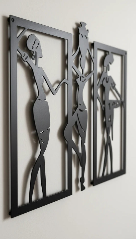 Three black metal wall art pieces with silhouetted figures on a white wall.