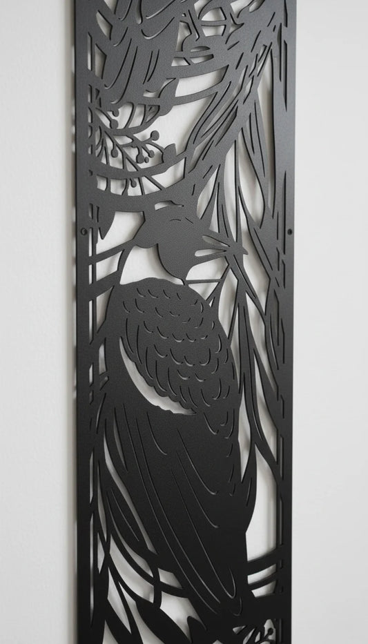 Decorative metal panel with cut-out design of a bird and leaves on a white background
