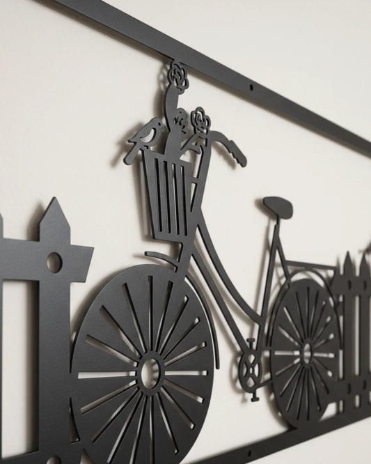 Decorative metal wall art of a bicycle with a basket and fence.