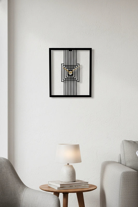 Framed abstract wall clock on a white wall above a side table with a lamp and books.