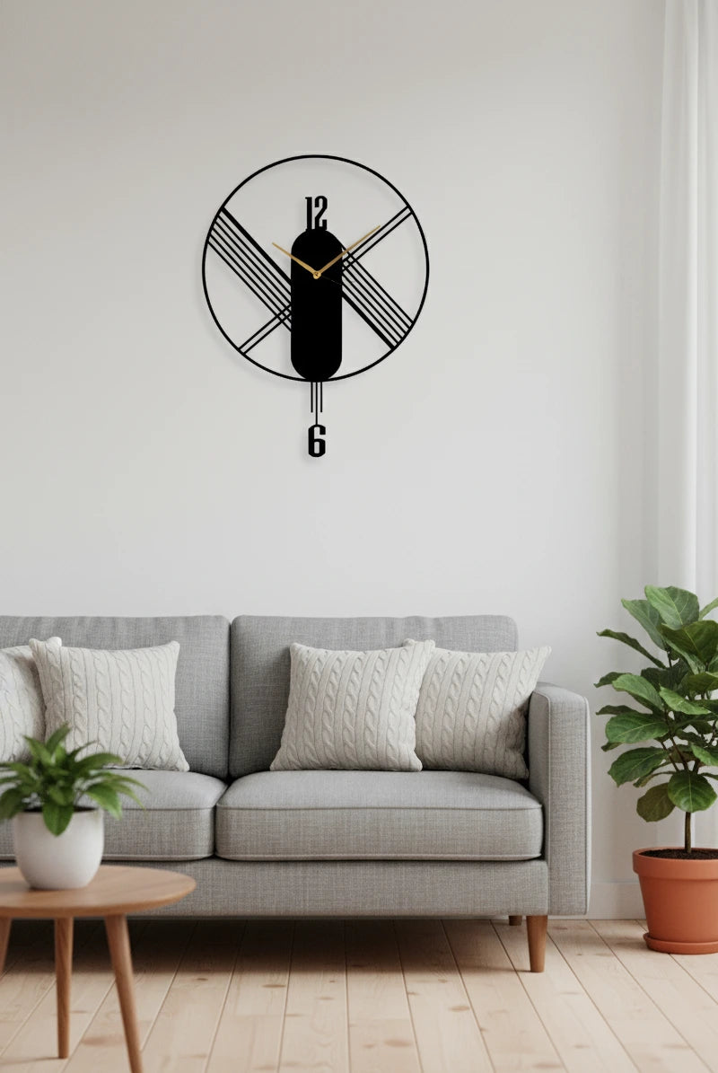 Decorative wall clock on a white wall above a gray sofa with plants on either side.