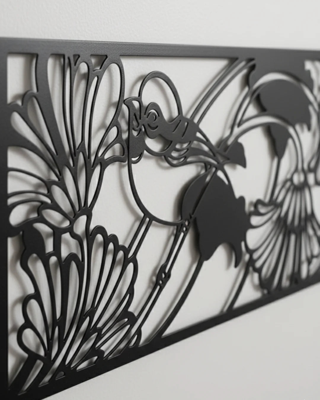Decorative metal screen with floral and bird design on a white background