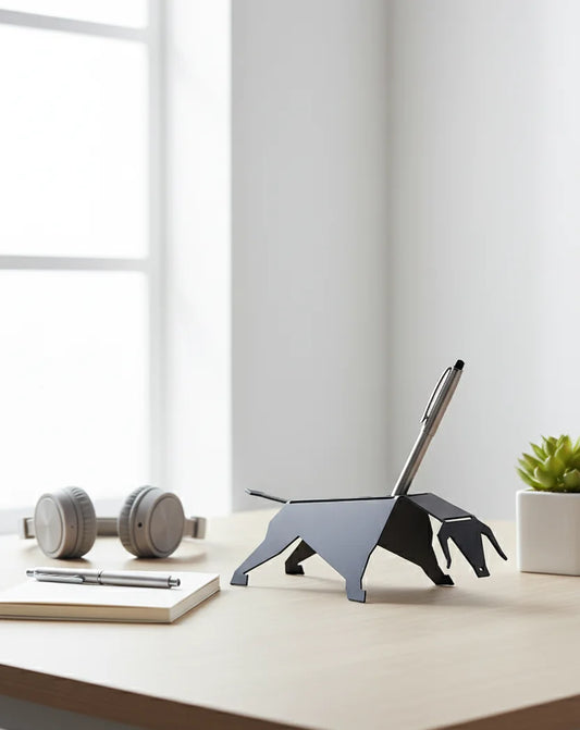 Dog-shaped pen holder on a desk with a notebook, pens, and a plant.