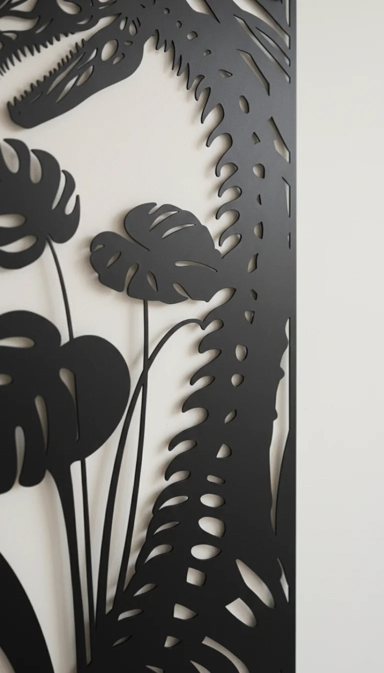 Decorative wall art with black cut-out plant shapes on a white background