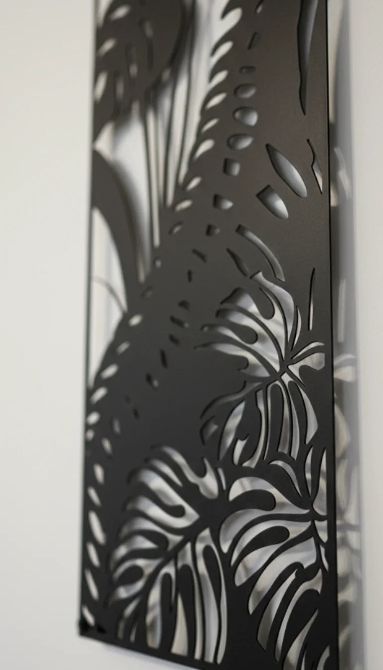 Decorative metal panel with laser-cut leaf patterns on a white background