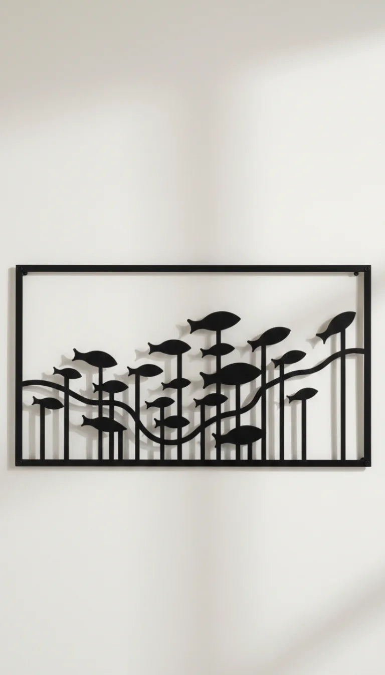 Decorative wall art with black leaf-like shapes on a white wall
