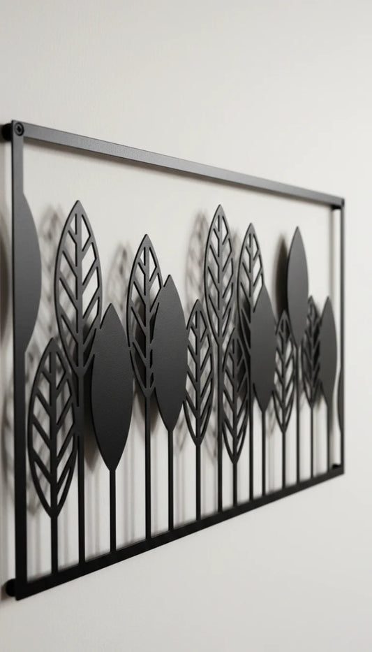 Decorative metal wall art with leaf patterns on a white background