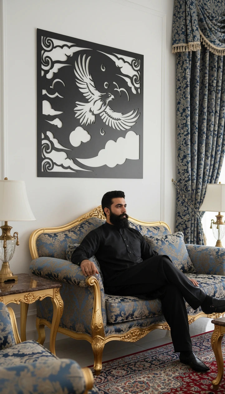 Man sitting on an ornate sofa in a luxurious room with decorative wall art and curtains.