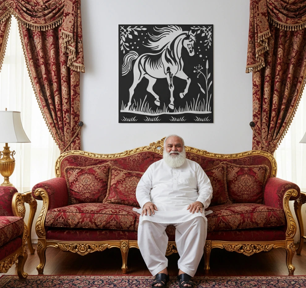 Man sitting on an ornate red and gold sofa with decorative curtains and a horse painting in the background.