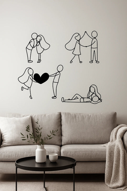 Wall with black line valentines day couple love art illustrations above a desk with a laptop, lamp, and plant.