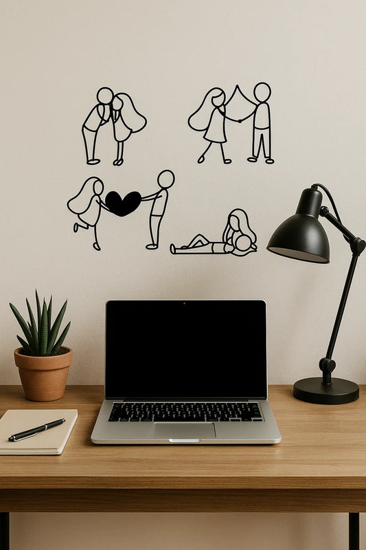 Wall with black line valentines day couple love art illustrations above a desk with a laptop, lamp, and plant.