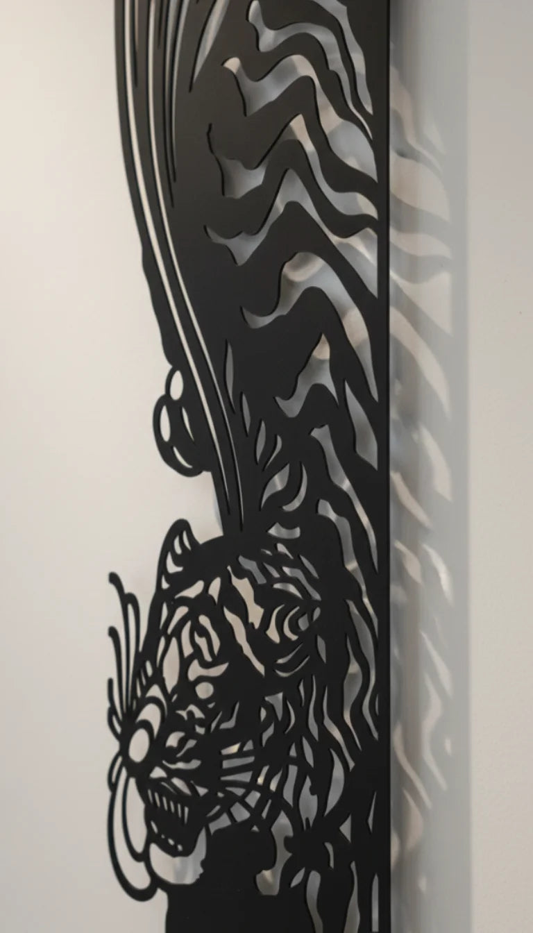 Decorative metal wall art with a tiger design on a white background