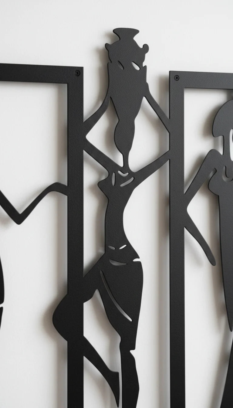 Black metal wall art of abstract figures on a white background