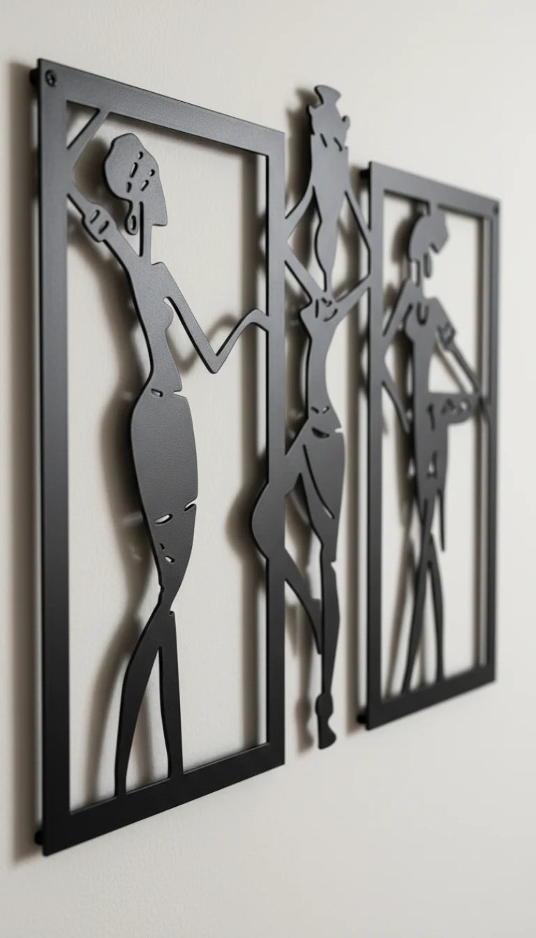Three black metal wall art pieces with silhouetted figures on a white wall.