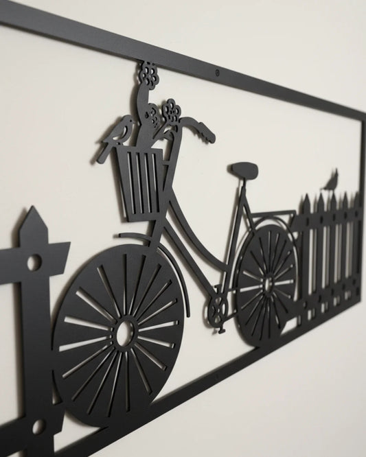 Decorative metal wall art of a bicycle with a basket and fence design.