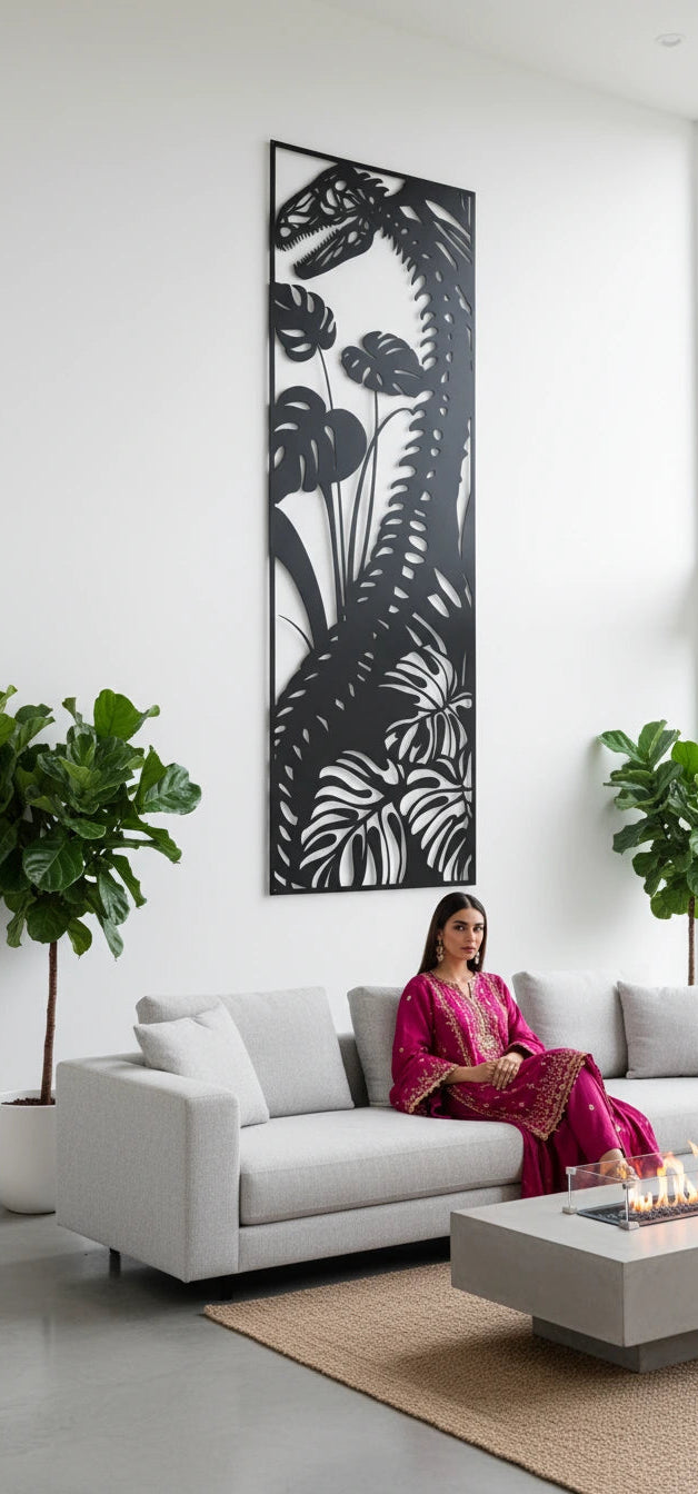 Woman in a pink dress sitting on a white sofa in a modern living room with decorative plants and metal wall art.