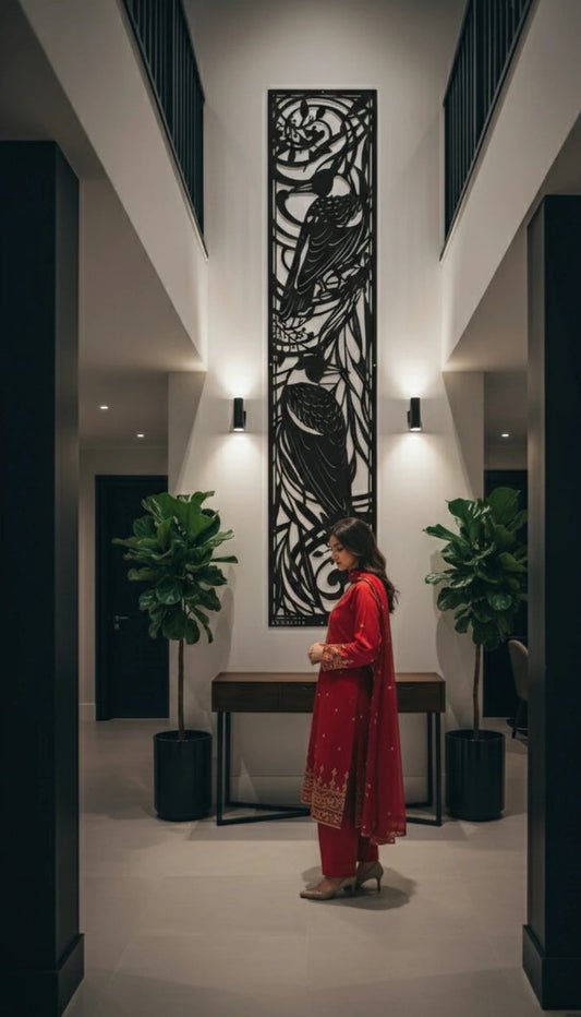 Woman in a red outfit standing in a modern interior setting with decorative wall art.