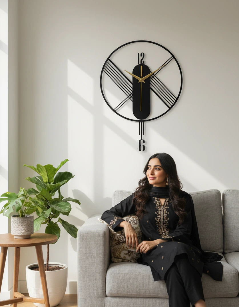 Woman sitting on a couch in a living room with a decorative wall clock.